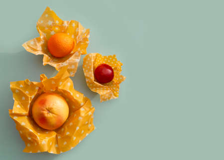 Reusable food beeswax wrappers in different sizes. Organic fabric covers for storing food. Zero waste concept. Creative still life.の写真素材