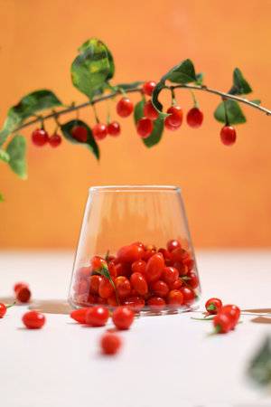 Fresh Goji berries in transparent glass. Healthy antiage superfood. Immune system booster.