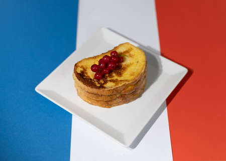 Traditional French toast with figs and red currants. Fried bread soaked in a mixture of milk, eggs and sugar.の写真素材