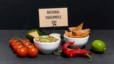 The ingredients for making Spicy Guacamole are avocado, red onion, tomato, chili, lime, cilantro, and garlic. National Guacamole Day.の写真素材
