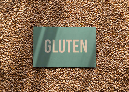 Wheat grains background with gluten inscription. Gluten is the general name for the proteins found in certain cereal grains.の写真素材