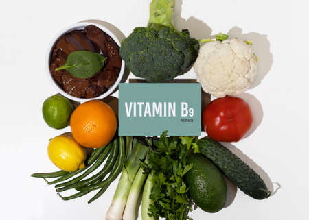 A set of natural products rich in vitamin B9 folic acid. Healthy food concept. Cardboard sign with the inscription.の写真素材