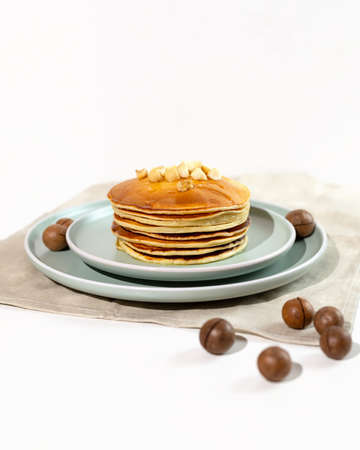 Stack of macadamia pancakes sprinkled with chopped nuts. Traditional Hawaiian dessert.の写真素材