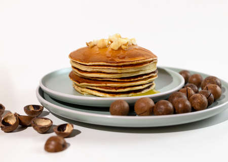 Stack of macadamia pancakes sprinkled with chopped nuts. Traditional Hawaiian dessert.の写真素材