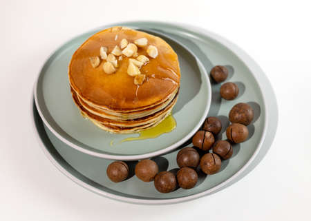Stack of macadamia pancakes sprinkled with chopped nuts. Traditional Hawaiian dessert.の写真素材