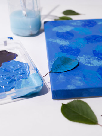 DIY Abstract botanical art. The picture is made by applying acrylic paints on the leaves and...