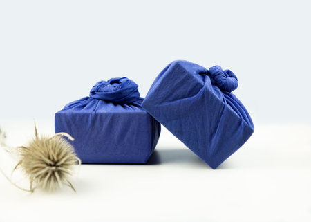 Furoshiki is the art of Japanese cloth wrapping, traditionally used in Asia for gifts. Recyclable packaging that reduces waste. zero waste concept, selective focusの写真素材