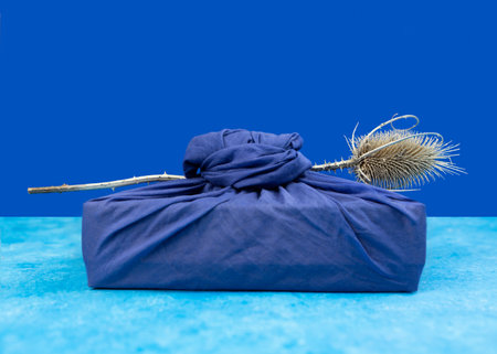 Furoshiki is the art of Japanese cloth wrapping, traditionally used in Asia for gifts. Recyclable packaging that reduces waste. zero waste concept, selective focusの写真素材