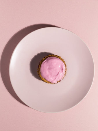 Napolitaine are typical Mauritian pastries adapted to the keto diet. The cookies are made with almond flour, layered with raspberry jam and topped with cream cheese cream on pink background.の写真素材