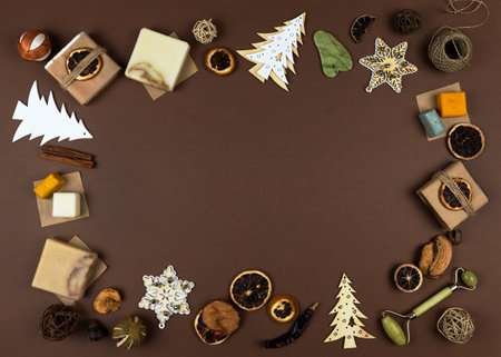 Frame made of dried oranges, handmade soap with natural essential oils, wooden Christmas decorations. Elements of a corporate or personal New Year's gift. Natural earth colors brown and white, no plastic. copy spaceの写真素材