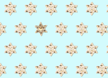 Geometric Christmas pattern made of wooden toy snowflakes on a pastel blue background. winter concept. flat lay.の写真素材
