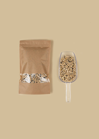 Brown kraft paper doypack bags with black-eyed peas on a yellow background. Packaging for foods and...