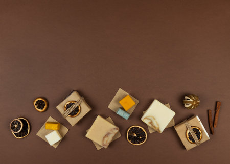 Frame made of dried oranges, handmade soap with natural essential oils, wooden Christmas decorations. Elements of a corporate or personal New Year's gift. Natural earth colors brown and white, no plastic. copy spaceの写真素材