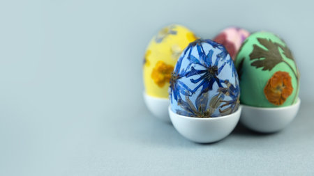 Multicolored wooden Easter egg decorated with pressed dried flowers. fashion spring colors. Art ideas for Easter.の写真素材