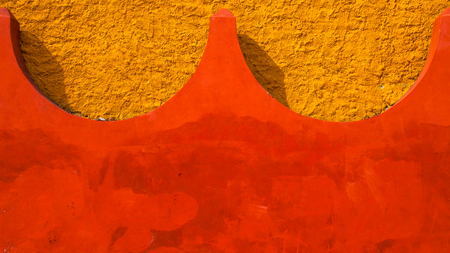 Abstract background colored in yellow and red color of concrete.の写真素材