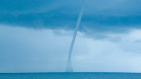Tornado on the sea during a thunderstorm.