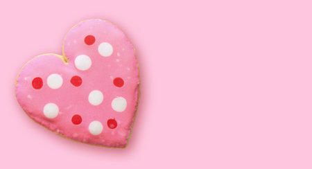 Edible heart-shaped cookies on a pink backgroundの写真素材