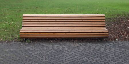 Bench made of wooden bars in a city parkの写真素材