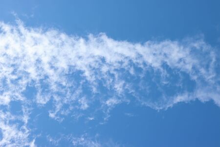 White, rare clouds in the blue sky.の写真素材
