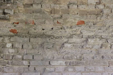 Background of old, destroyed, painted brickwork of a building.の写真素材
