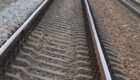 Railroad, concrete sleepers and rails with covered rubble.の写真素材