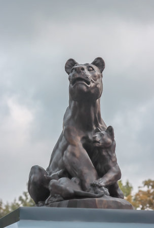 Bronze statue of a predator lioness with a lion cub on the roof of the Kaliningrad Zoo. Photographed...