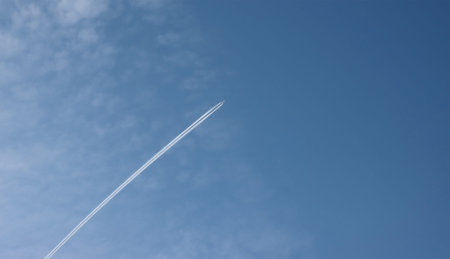 Passenger plane flying against the blue sky.
