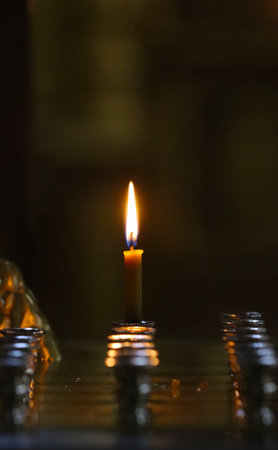 Wax candle burning in a Christian church.