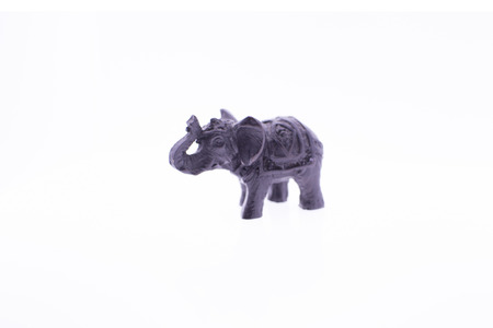 Brown elephant figurine on a white backgroundの写真素材