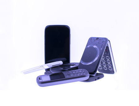 Pile of old mobile phones on white backgroundの写真素材