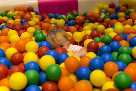 Child boy in jimbori colored ballsの写真素材