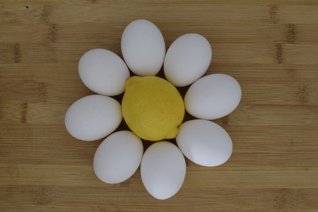 Limon eggs flower kitchen composition on wooden plankの写真素材