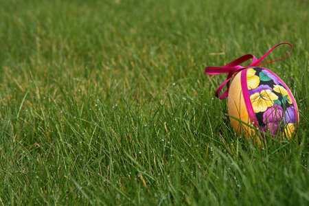 hand crafted colorful easter eggs in a green meadowの写真素材