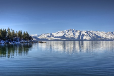 A reflection of Elk Point on Lake Tahoe from Marla Bay with Pyramid Peak and Mount Price reflecting in the background. の写真素材