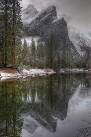 A reflection of the Three Brothers on the Merced River in Yosemite National Park.の写真素材