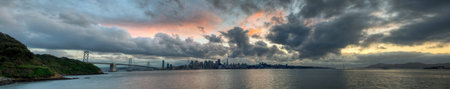A panoramic skyline of San Francisco with a colorful sunset.の写真素材