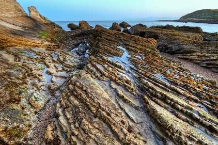 The layered rocks in Spooners Cove in Montana De Oro State Park.の写真素材