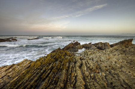 Sunrise colors above the surf on the Pacific coast in Montana De Oro State Park, California.の写真素材