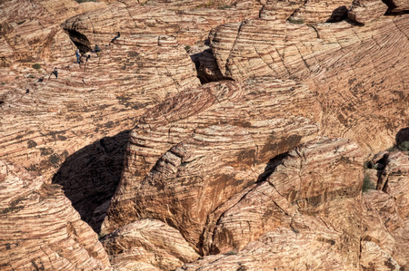 Hikers climb on the red rocks of Red Rock Canyon, Las Vegas, Nevada.の写真素材