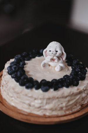 Easter cake with white bunny and blueberries. Selective focus.の写真素材