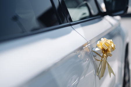 Blue tape on the car door. Wedding decoration on the car door handle. Ceremonial ribbon on transport.の写真素材