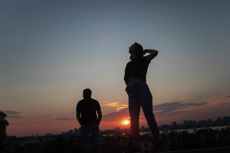 Couple in love silhouette during sunset - touching nosesの写真素材