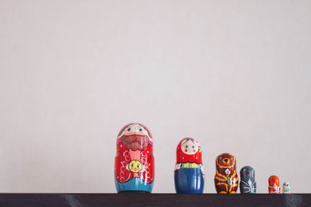 Five red matryoshka. Traditional Russian toy. Copy space. White wooden background