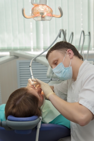 The doctor the dentist accepts the patient on the workplace in an office.の写真素材