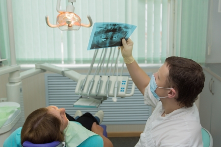 The doctor the dentist accepts the patient on the workplace in an office.の写真素材