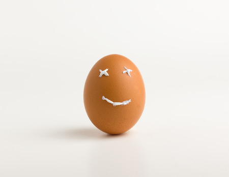 egg with a smile from a toothpaste on a white backgroundの写真素材