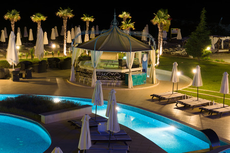 night hotel with the pool and trees the excellent vacation spot of touristsのeditorial素材