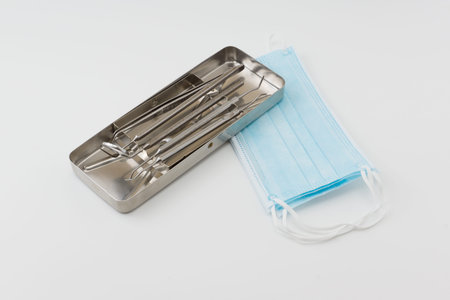 tools of the dentist lie in a steel tray after sterilizing processing