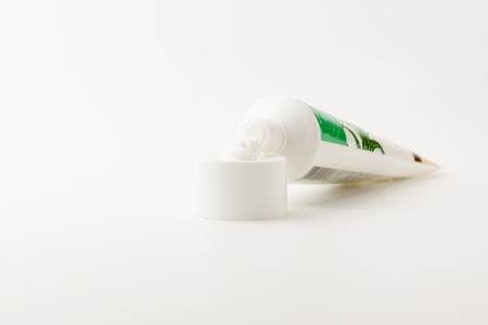tube with a small amount of the squeezed out white creamの写真素材