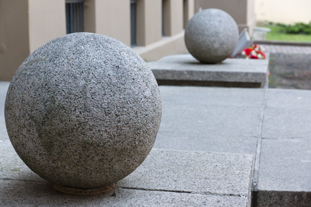 two big granite full-spheres are located at an input to the buildingの写真素材